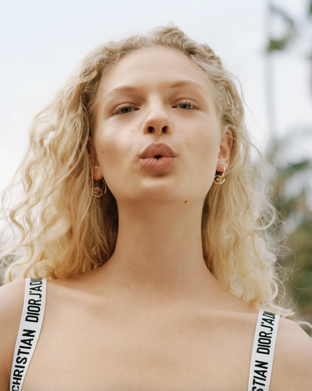 woman pursing her lips wearing christian dior top vogue cover story