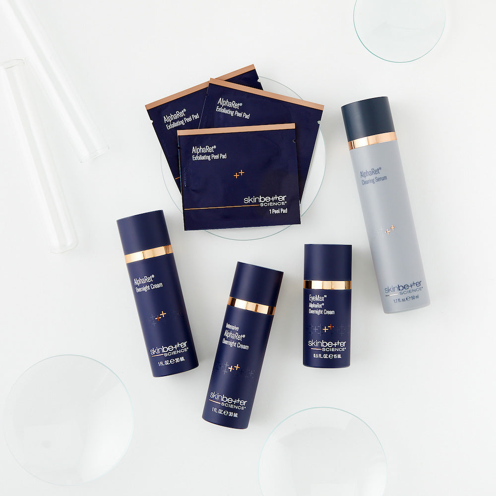 flat lay of skinbetter product shots, including alpharet overnight cream, alpharet peeling pads, intensive overnight cream, eyemax overnight cream, and alpharet clearing serum