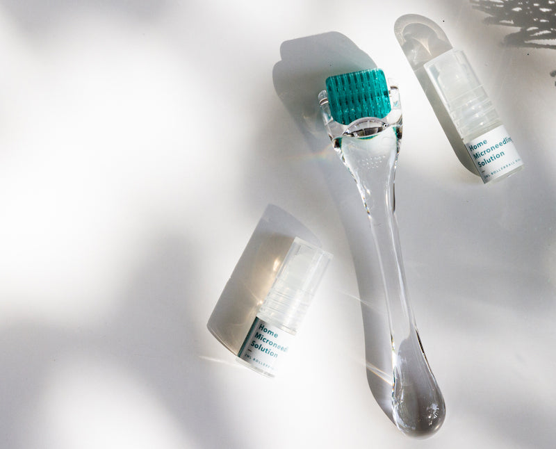 flat lay of anteage microneedling dermal roller and two vials of stem cells with cytokines