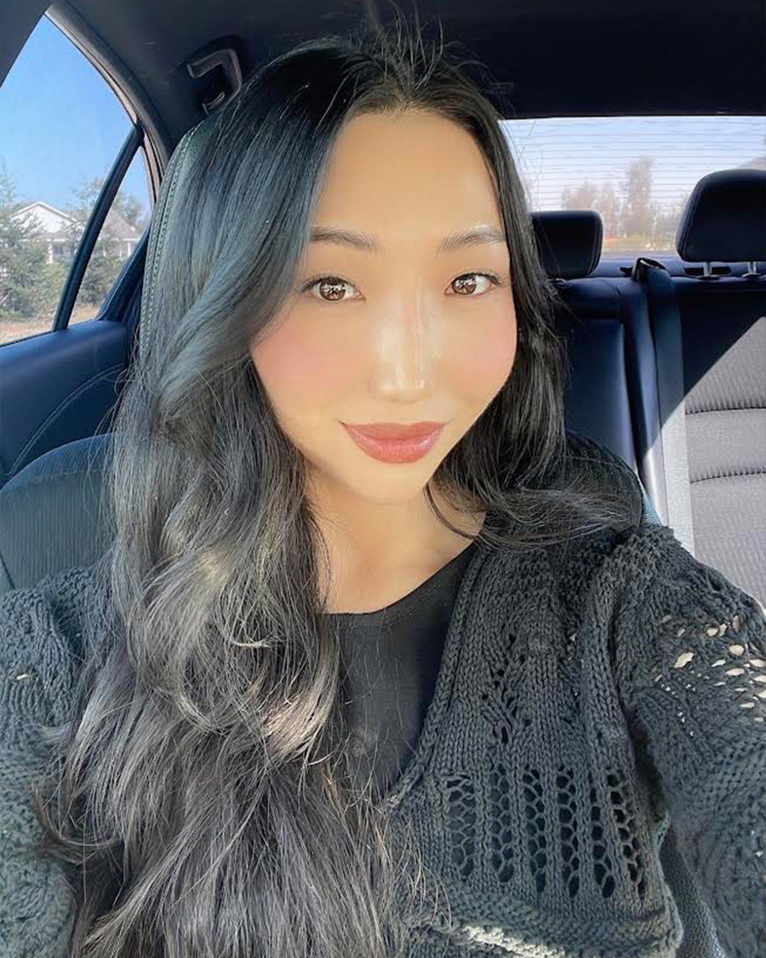 selfie of an asian woman with clear skin who is our client