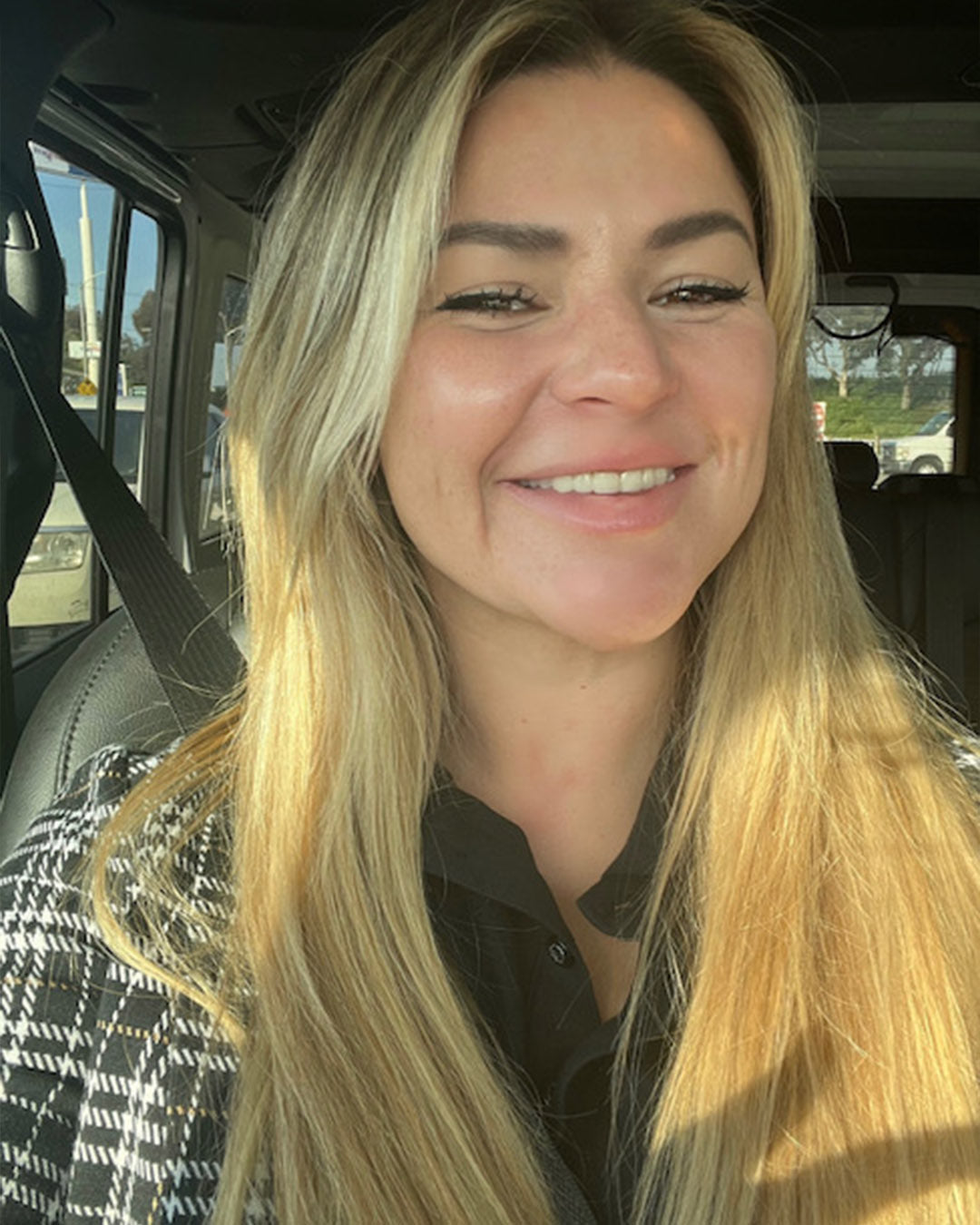 selfie of a blonde white woman smiling who is our client