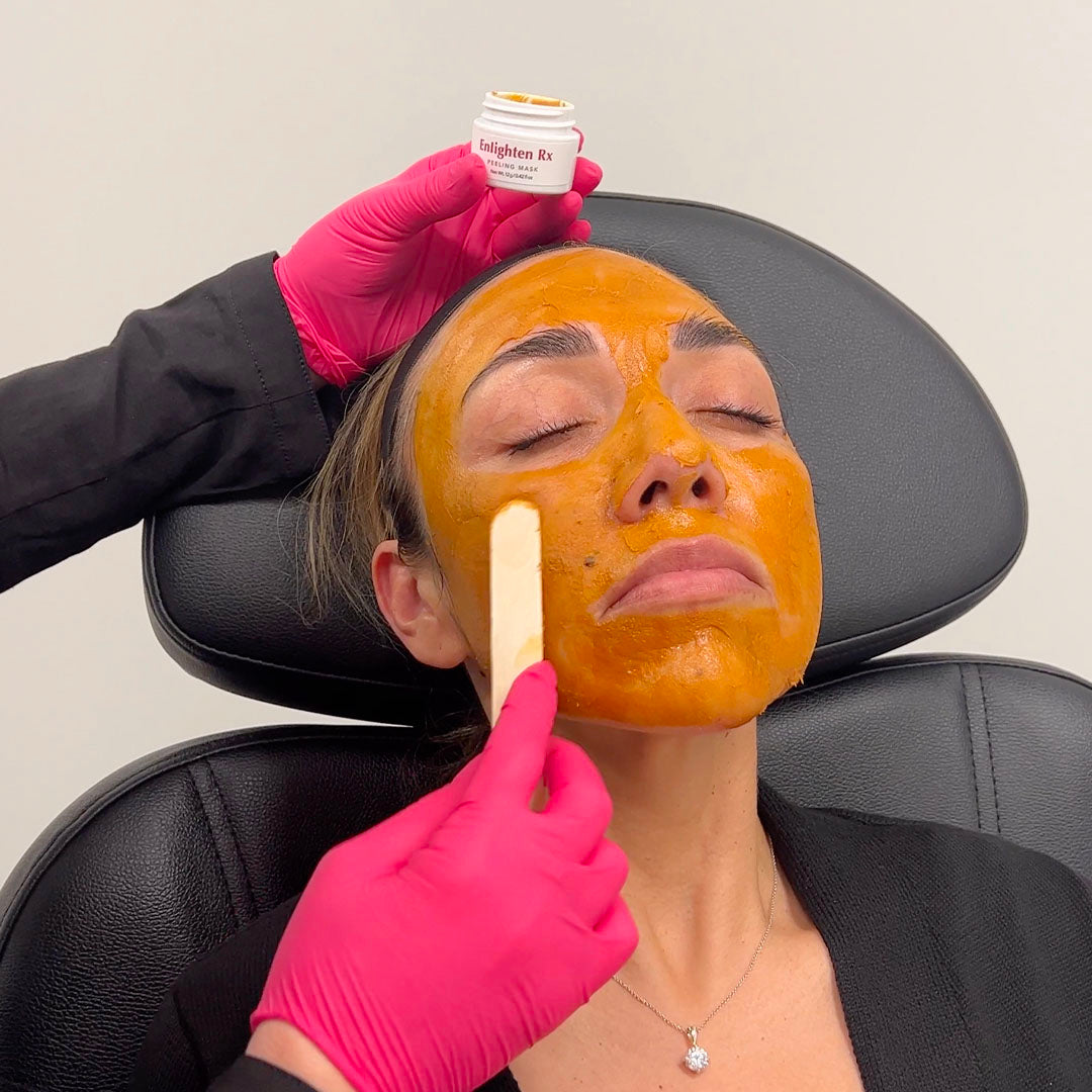 a photo of a patient receiving a chemical peel treatment to her face