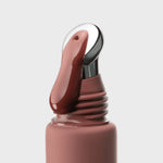close-up of ÂN-GLOSS Ceramide Spice Cake Lip Tint coming out of the tube