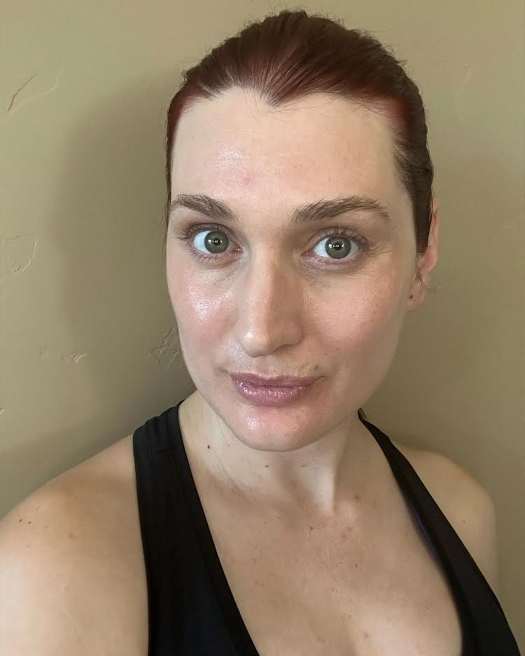 selfie of our client, a red headed woman with clear skin