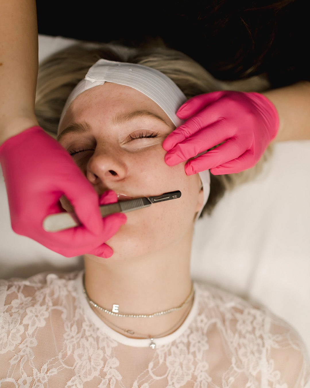 woman receiving dermaplaning before custom signature facial at revay aesthetics