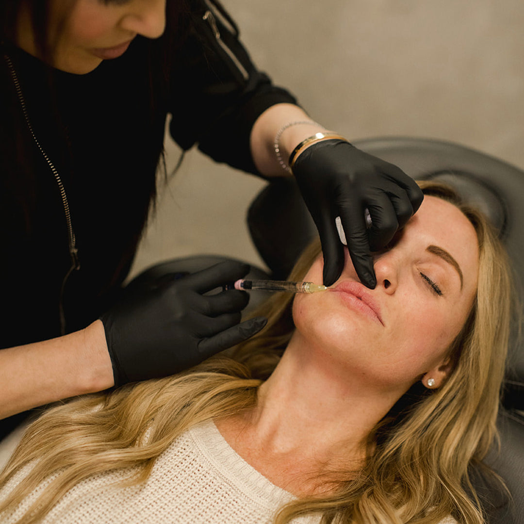 woman receiving lip fillers from Revay Aesthetics