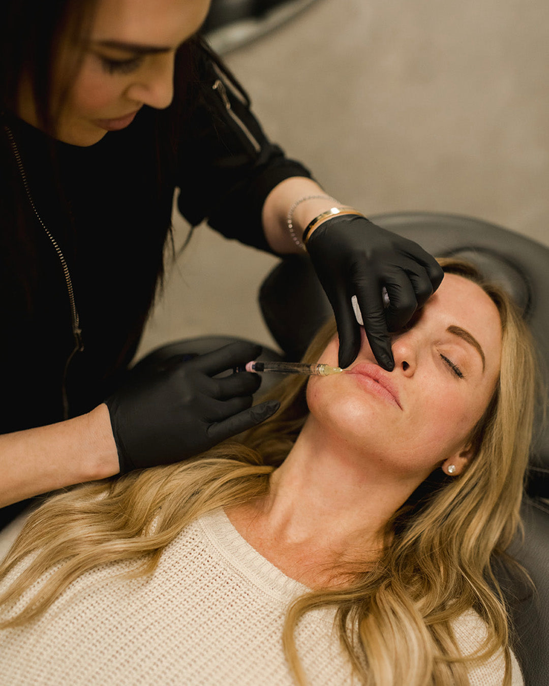 woman receiving lip fillers from Revay Aesthetics