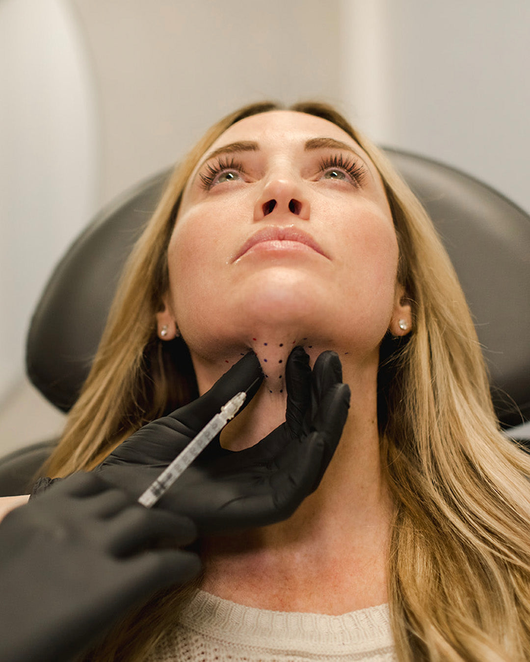 woman receiving kybella injections for double chin from Revay Aesthetics