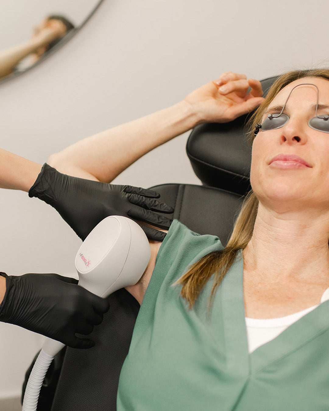 woman receiving laser hair removal to underarms from revay aesthetics